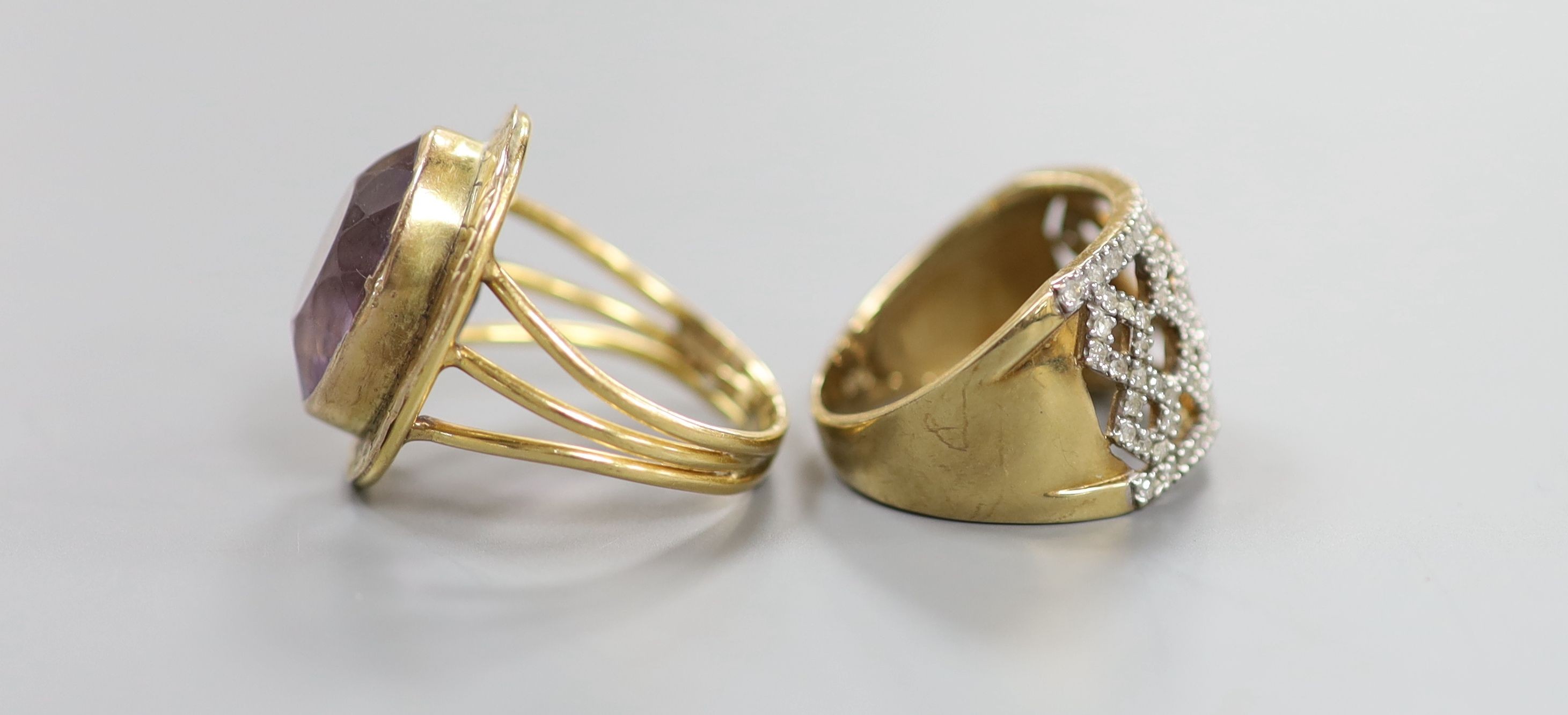 A modern pierced 9ct gold and diamond chip set dress ring, size P, gross 4.5 grams and a yellow metal and amethyst set oval dress ring, size N, gross 7.2 grams.